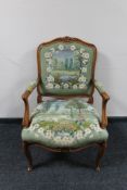 An antique style carved walnut armchair in tapestry fabric