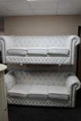 A pair of white studded leather three seater Chesterfield style settees