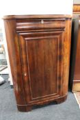 A nineteenth century mahogany corner cabinet