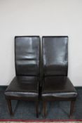 A pair of brown leather dining chairs