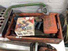 A plastic storage box containing saws, joint master,