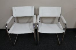 A pair of white stitched leather tubular chairs