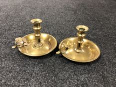 A pair of antique brass chamber sticks