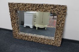 A rustic wooden framed overmantel mirror
