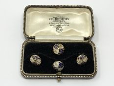 A set of 4 gold white and black enamel studs, 4.25g.