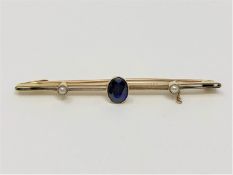 A 15ct gold brooch set with a sapphire, 2.9g.