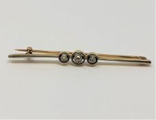 An 18ct gold and platinum three stone diamond brooch, 4.13g.