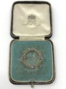 An antique yellow metal (tests 14ct gold) sapphire and pearl brooch, 3.6g in original box.