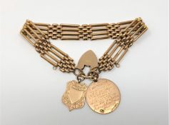 A 9ct gold gate bracelet with two 9ct gold fobs attached, 23g.