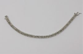A 10ct white gold diamond line bracelet,