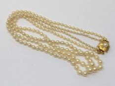 A 20 inch double strand of pearls on 14ct gold clasp
