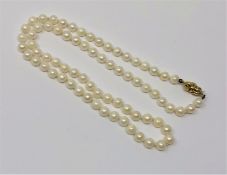 A 20 inch strand of pearls of 18ct gold clasp