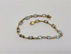 A 10ct gold blue topaz bracelet,