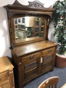 A Victorian carved oak mirror back sideboard