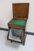 An Edwardian oak coal cabinet