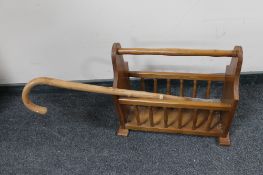 A mahogany magazine rack and a walking stick