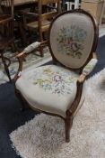 A carved walnut salon tapestry armchair