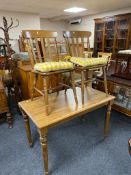 A contemporary oak kitchen table and two chairs