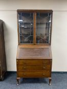 An Edwardian oak bureau bookcase