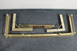 An Edwardian brass extending fire curb together with one further curb