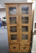 A contemporary double door glazed cabinet on stand