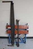 A folding Work mate workbench together with a large metal saw and a metal clamp