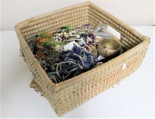A wicker crate of costume jewellery