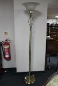 A brass floor lamp