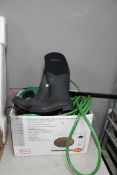 A box containing hose pipe, pair of boots,