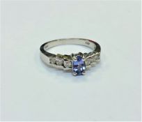 A 14ct white gold tanzanite and diamond ring, size N. CONDITION REPORT: 2.8g.