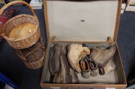 A vintage suitcase together with metal sign and boots