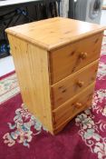A pine three drawer chest