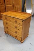 A pine four drawer chest