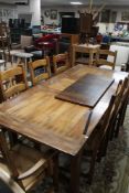 A good quality reproduction farmhouse extending dining room table together with a set of eight