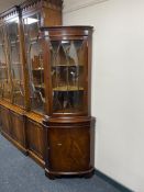 A reproduction mahogany corner cabinet