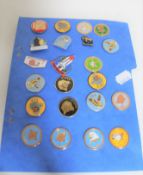 A collection of enamelled metal badges