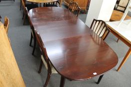 A mid century extending oval dining table and four chairs.