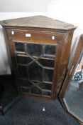 An Edwardian stained pine corner cabinet