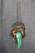 A Black and Decker electric hedge cutter