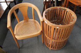 A circular wooden waste bin and a beech framed armchair