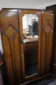 An Edwardian oak mirror door wardrobe