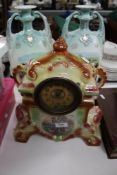An Edwardian ceramic clock together with a pair of transfer printed vases