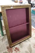 A gilt display wall cabinet