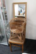 A hall mirror together with a wicker chair and dining chair