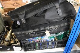 A crate and a suitcase of bric a brac, CD's, DVD's, clothing etc.