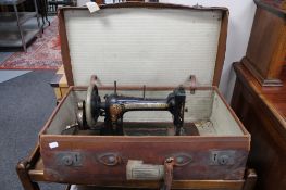 A Victorian Bradbury's sewing machine in vintage leather case