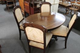 An antique oval occasional table and four 19th century mahogany dining chairs.