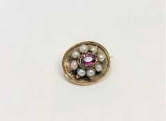 A gold pearl and garnet brooch