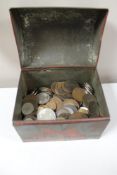 A vintage tin containing coins