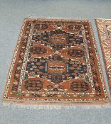 An Afghan Bokhara rug on rust ground,
